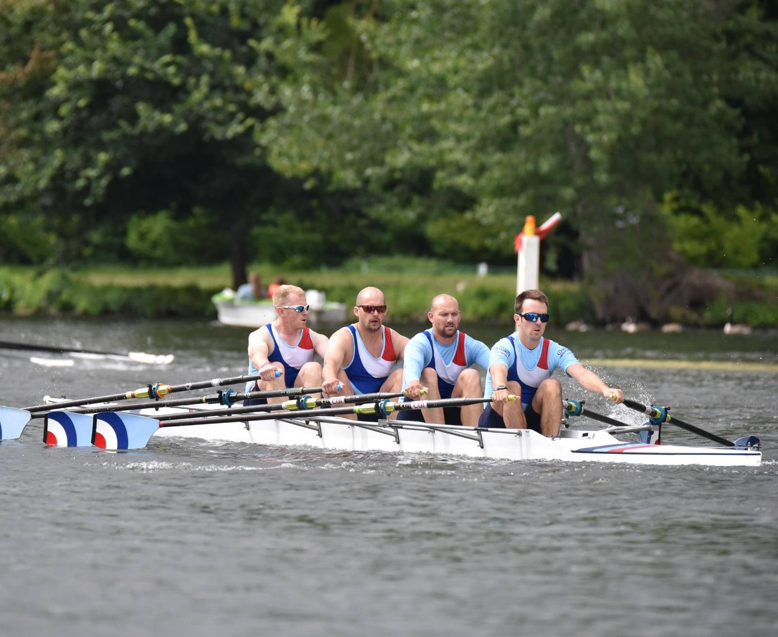 Personnel rowing for the RAF on a river. 